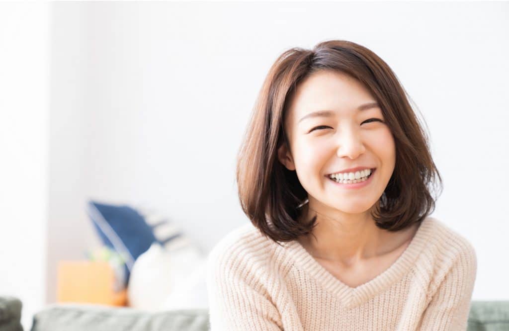 Smiling woman sitting on sofa